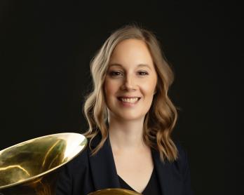 Headshot of Kiirsi Maunula Johnson with french horn